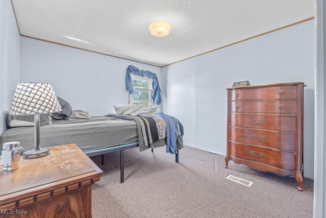 bedroom featuring crown molding and carpet floors