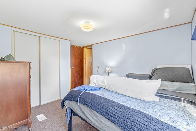 bedroom featuring a closet and light colored carpet