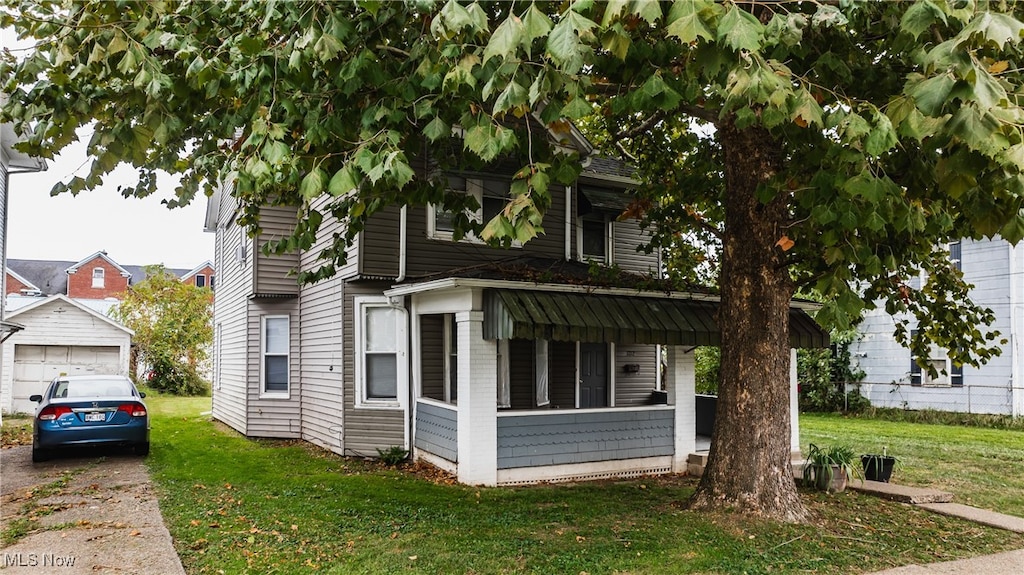 view of front of property with a front yard and a garage