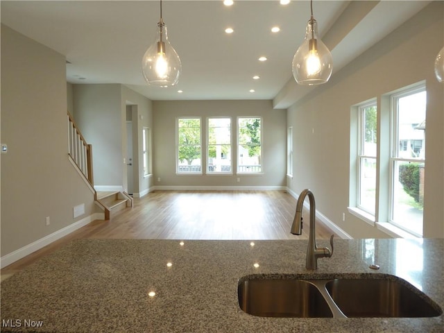 4424 W 53rd St, Cleveland, OH 44109 - kitchen with a sink, stone counters, recessed lighting, open floor plan, and wood finished floors
