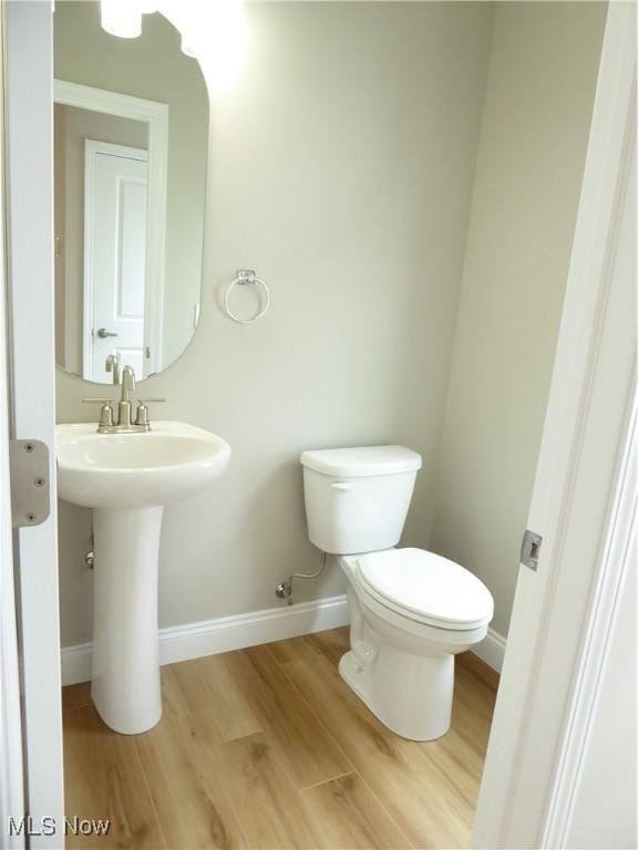 4424 W 53rd St, Cleveland, OH 44109 - bathroom featuring toilet, wood finished floors, baseboards, and a sink