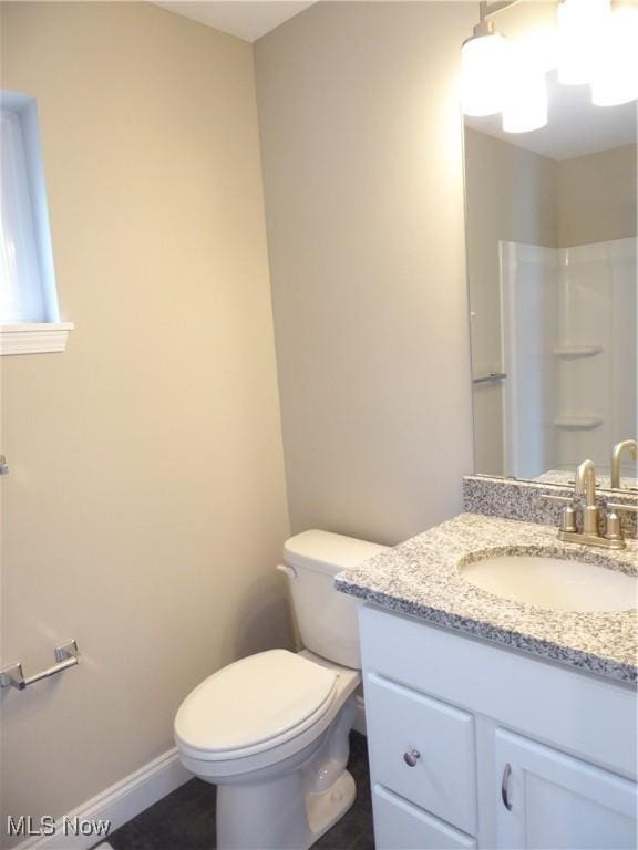 4424 W 53rd St, Cleveland, OH 44109 - full bath with vanity, toilet, a shower, and baseboards
