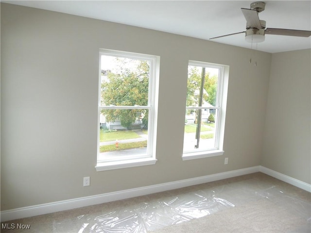 4424 W 53rd St, Cleveland, OH 44109 - spare room with light carpet, a ceiling fan, and baseboards