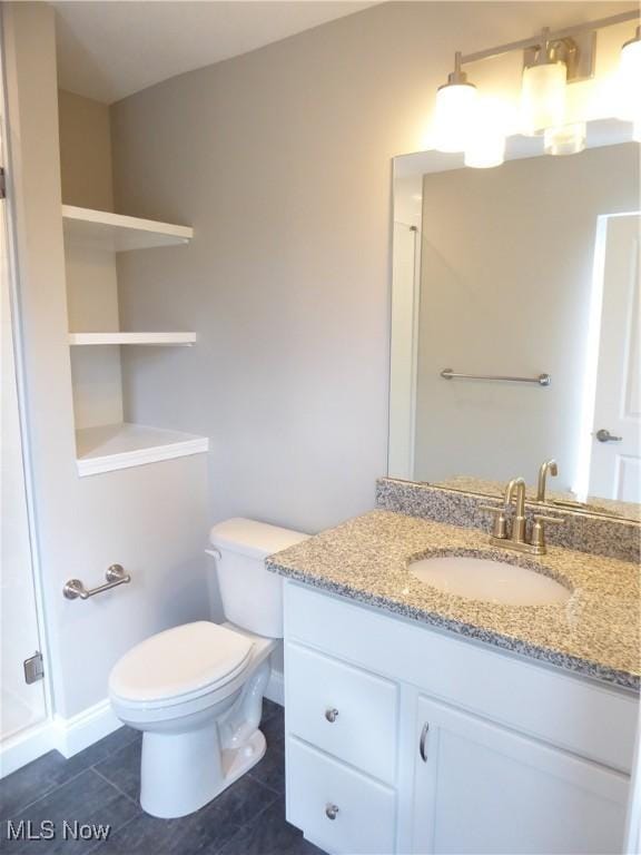 4424 W 53rd St, Cleveland, OH 44109 - full bathroom featuring tile patterned flooring, vanity, toilet, a shower stall, and baseboards