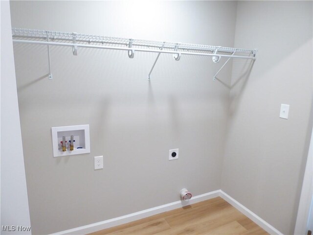 4424 W 53rd St, Cleveland, OH 44109 - laundry area with hookup for an electric dryer, light wood finished floors, baseboards, and hookup for a washing machine