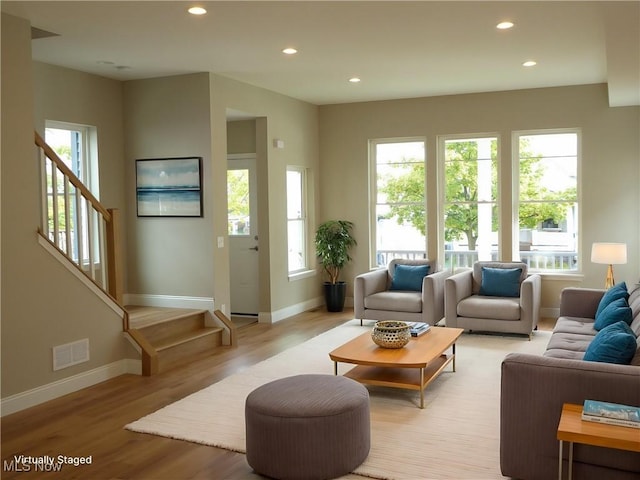4424 W 53rd St, Cleveland, OH 44109 - living area with baseboards, plenty of natural light, recessed lighting, light wood-style floors, and stairs