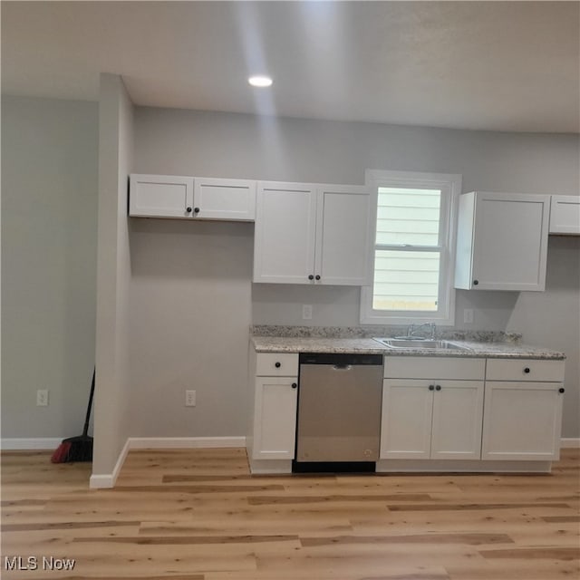 kitchen featuring dishwasher, light wood-type flooring, and white cabinets