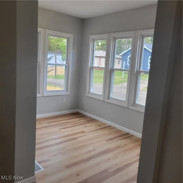 spare room with light hardwood / wood-style floors