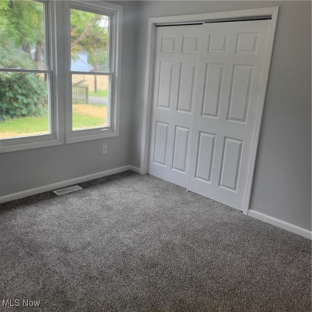 unfurnished bedroom featuring a closet and carpet flooring