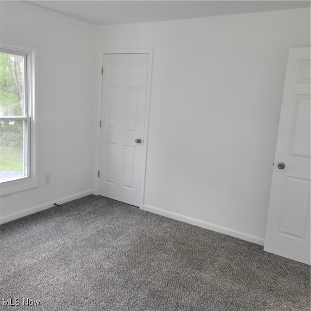 carpeted empty room featuring a healthy amount of sunlight