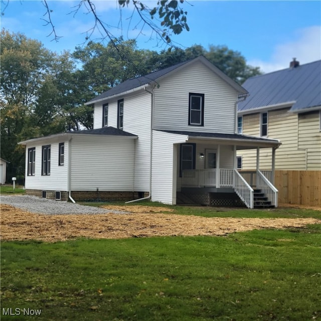 back of house featuring a porch and a lawn