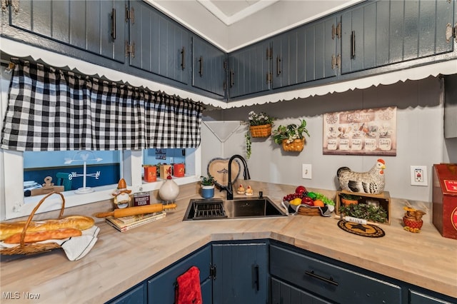 kitchen featuring blue cabinetry and sink