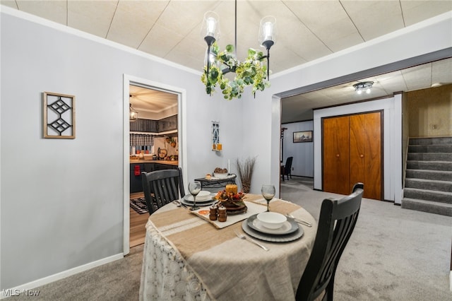 dining space featuring crown molding and carpet floors