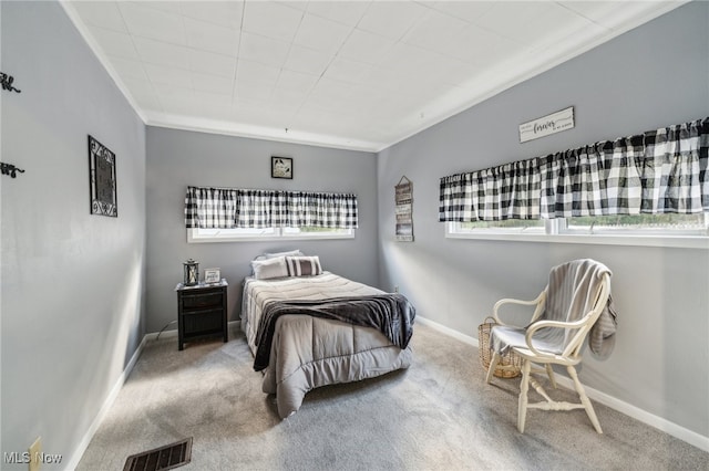 bedroom featuring crown molding and carpet floors