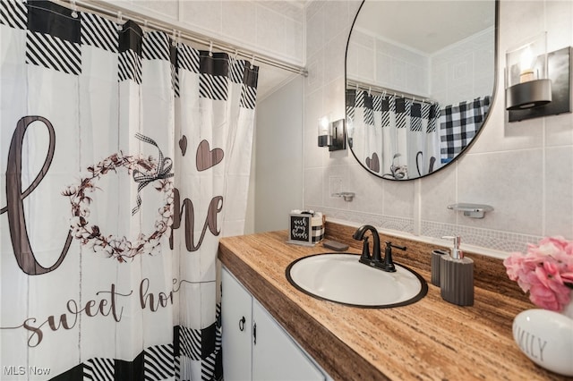 bathroom with vanity, decorative backsplash, a shower with curtain, and tile walls