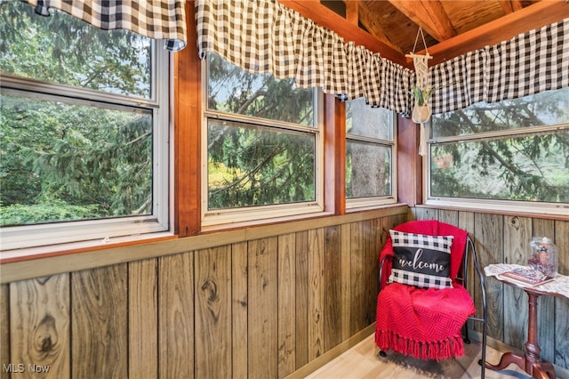 sunroom with beam ceiling and a healthy amount of sunlight