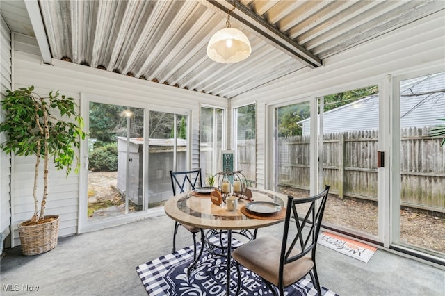 sunroom / solarium with lofted ceiling with beams