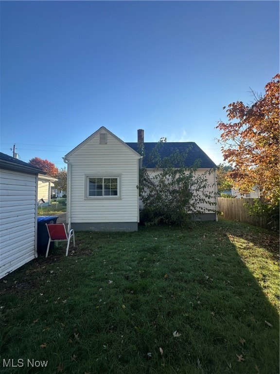 rear view of property featuring a yard