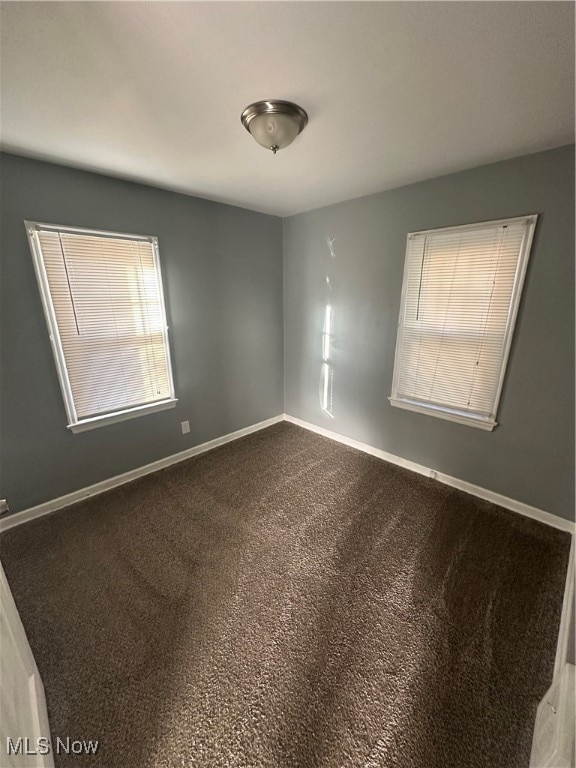 unfurnished room with carpet flooring