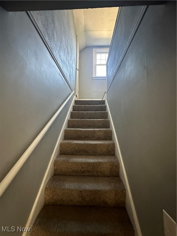 stairway with lofted ceiling