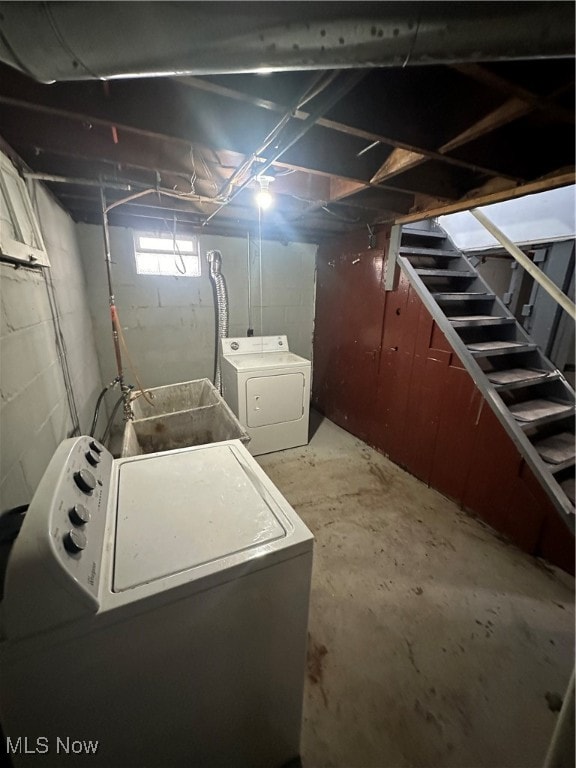 clothes washing area featuring separate washer and dryer