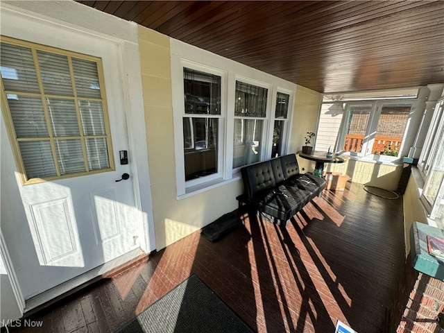 sunroom / solarium featuring a wealth of natural light and wood ceiling