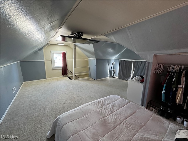 carpeted bedroom featuring a closet, ceiling fan, and vaulted ceiling