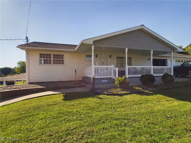 view of front facade featuring a porch, a garage, and a front yard