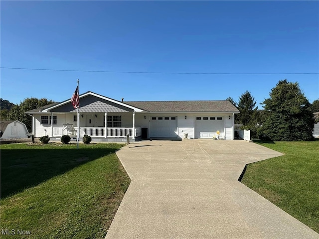 ranch-style home featuring a garage, covered porch, and a front lawn