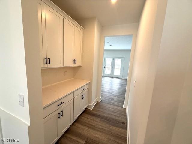 corridor featuring french doors and dark hardwood / wood-style floors