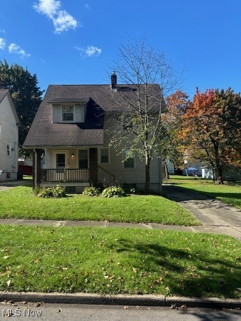 bungalow-style house with covered porch and a front lawn