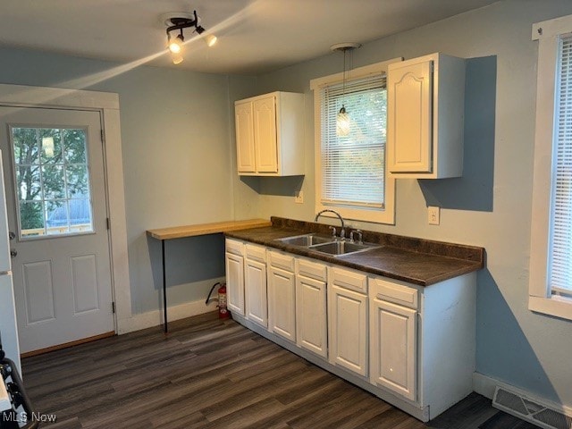 kitchen featuring sink, dark hardwood / wood-style floors, and white cabinets