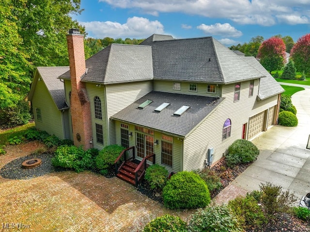 back of property featuring a garage