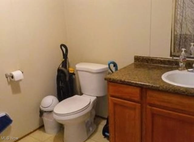 bathroom featuring vanity, toilet, and tile patterned flooring