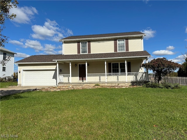 view of front of property featuring a garage, a front lawn, and a porch