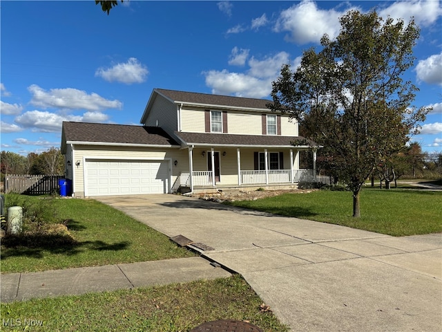 view of front of house with a garage, a front lawn, and a porch