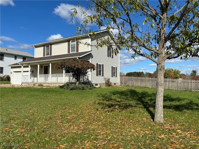 rear view of property featuring a yard, a porch, and a garage