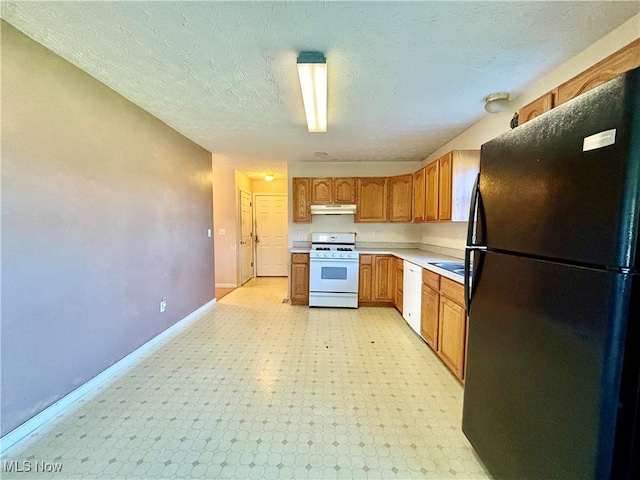 kitchen with a textured ceiling and white appliances