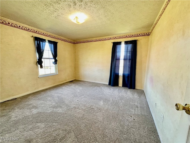 carpeted spare room featuring a textured ceiling