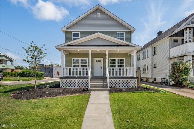 view of front of house with covered porch and a front lawn