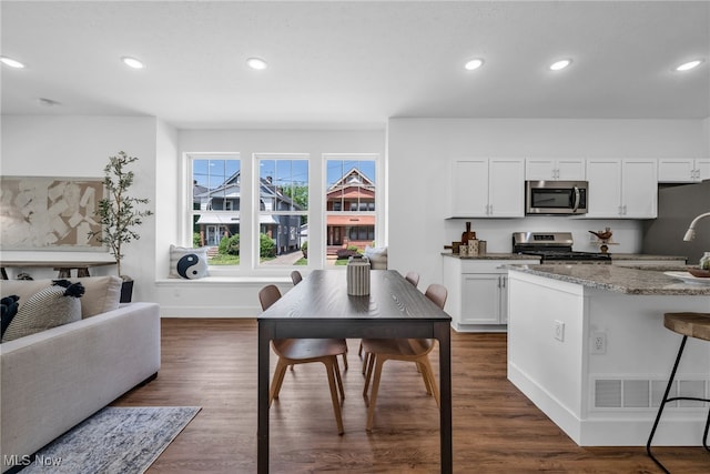 dining room with dark hardwood / wood-style floors