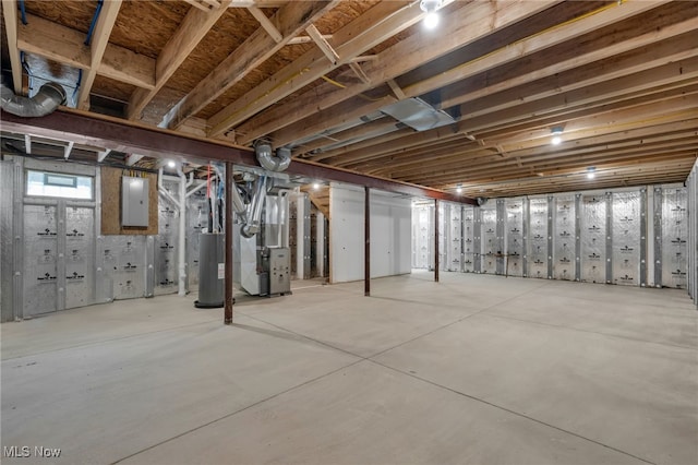 basement with heating unit, electric panel, and gas water heater