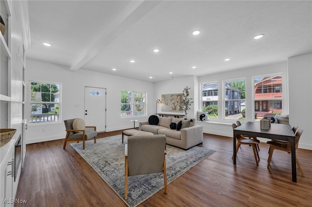 living room with beamed ceiling and dark wood-type flooring