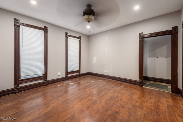 unfurnished bedroom with dark hardwood / wood-style flooring and ceiling fan