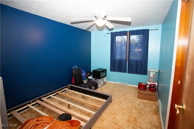 bedroom with carpet, a textured ceiling, and ceiling fan