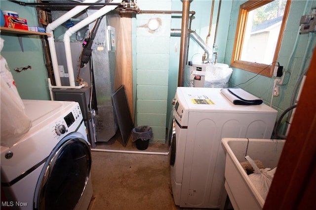 laundry room featuring independent washer and dryer and water heater