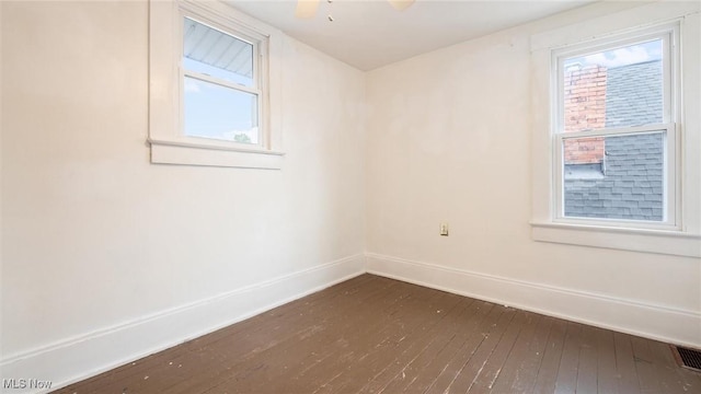 unfurnished room featuring dark hardwood / wood-style flooring and ceiling fan