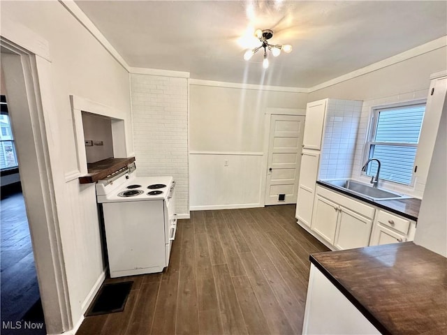 kitchen featuring white range with electric stovetop, dark hardwood / wood-style flooring, sink, and white cabinets