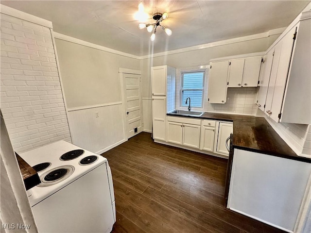 kitchen featuring white cabinets, dark hardwood / wood-style flooring, a notable chandelier, and sink