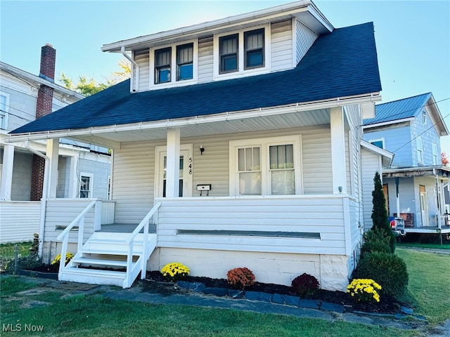 view of front of home featuring a front yard and a porch